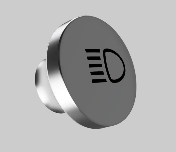 A round metallic car headlight switch knob with a black icon of a light beam and a D-shaped symbol on its face, shown against a solid gray background.